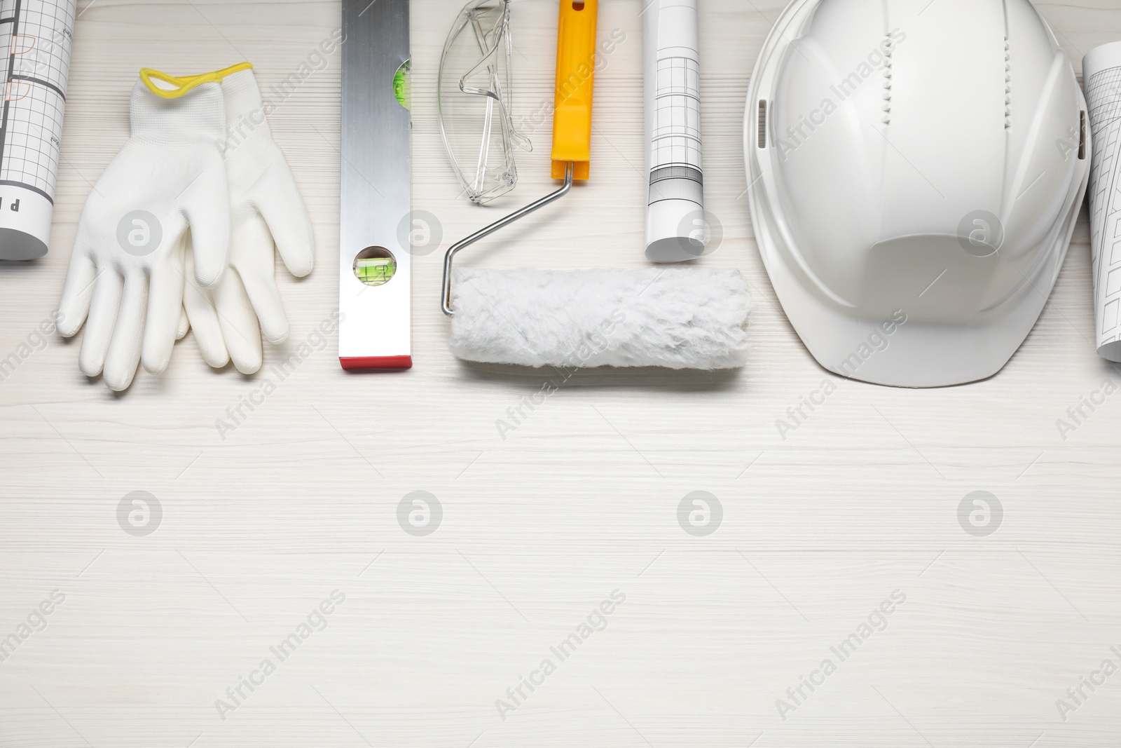 Photo of Flat lay composition with building level and other construction tools on white wooden table, space for text