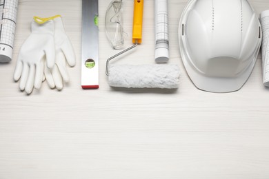 Photo of Flat lay composition with building level and other construction tools on white wooden table, space for text