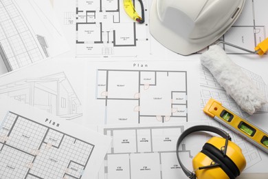 Photo of Flat lay composition with building level and other construction tools on papers