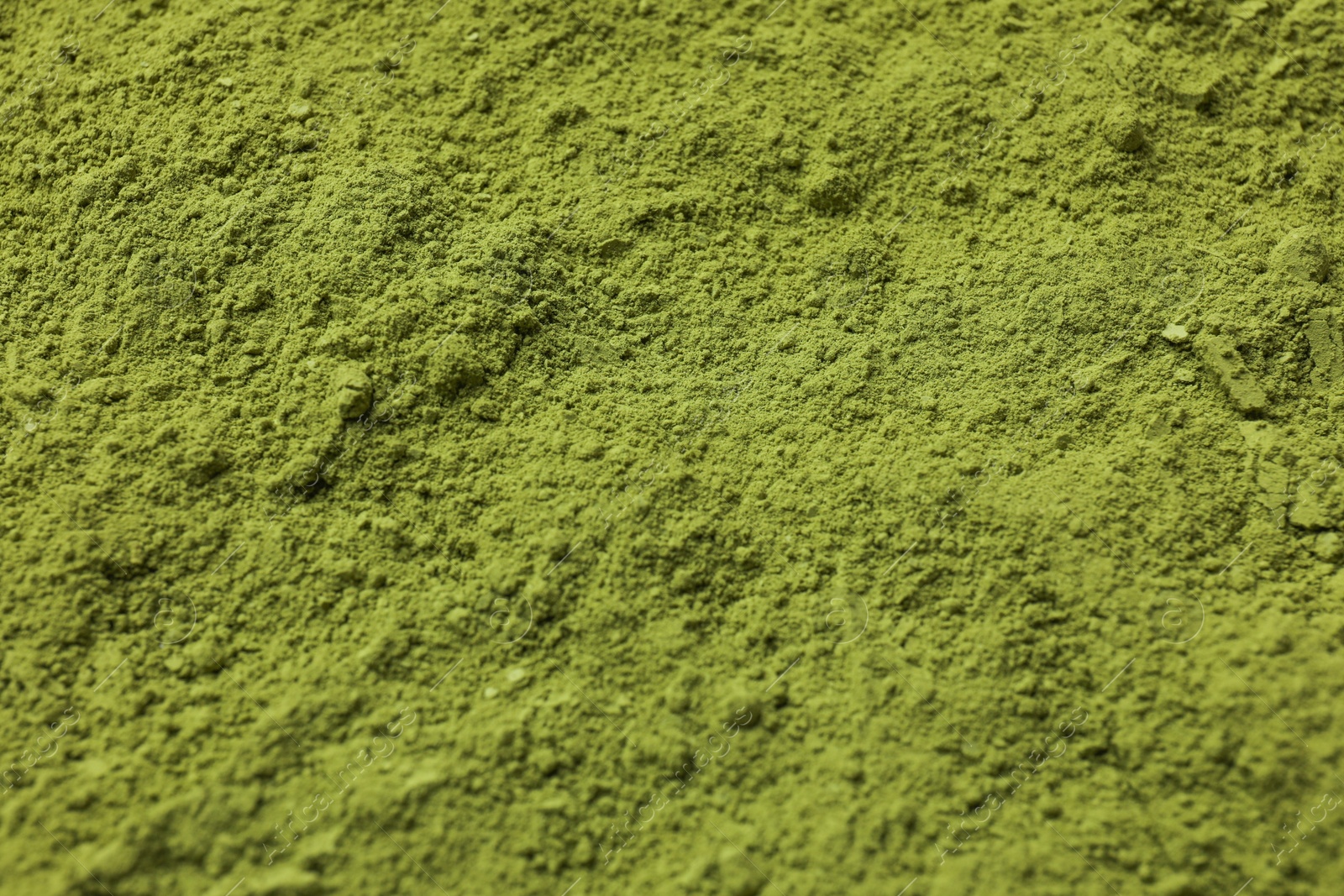 Photo of Green matcha powder as background, closeup view