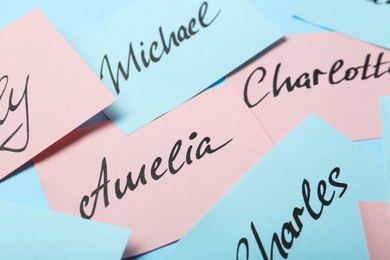 Paper stickers with different names, closeup. Choosing baby's name