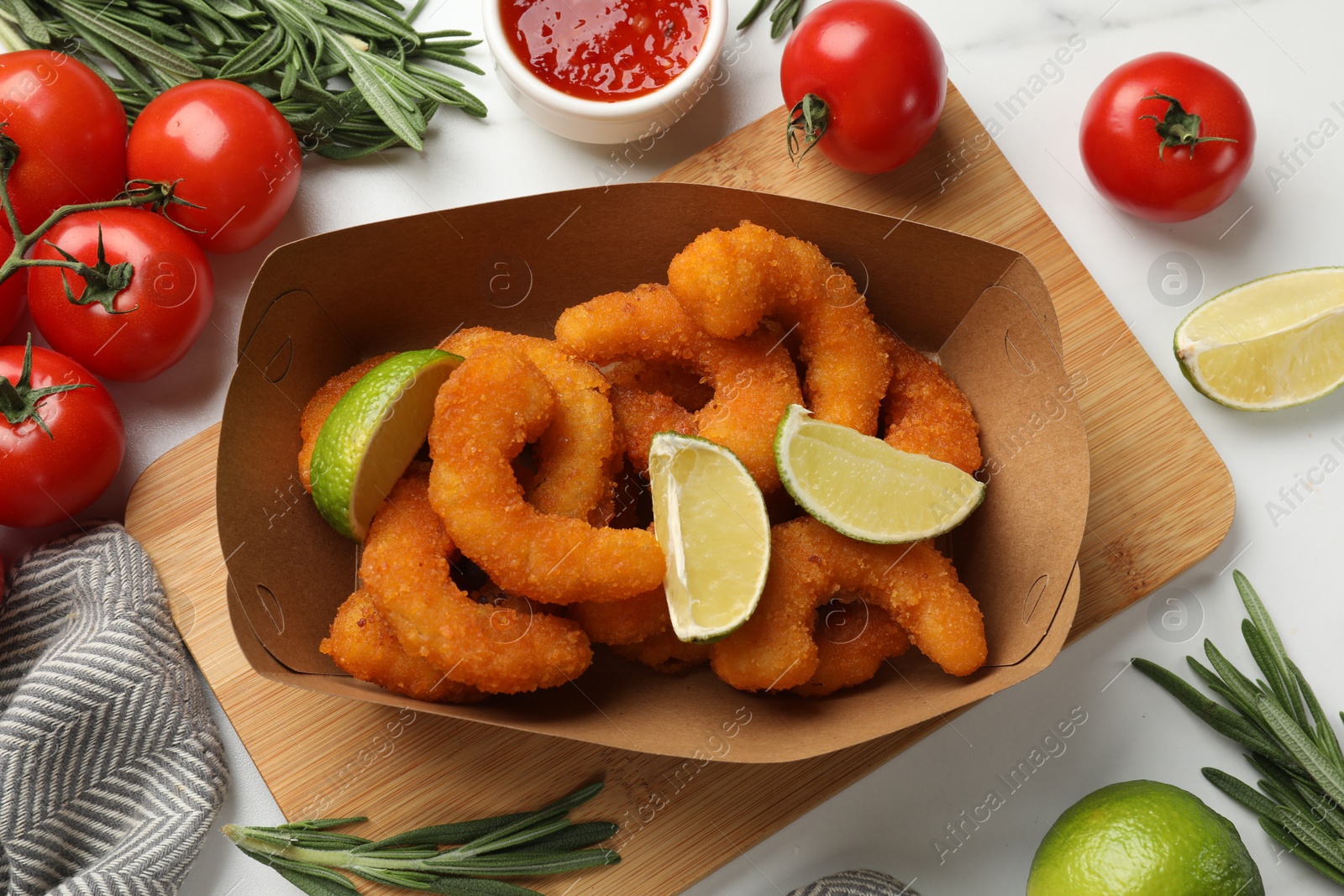 Photo of Delicious breaded fried shrimps served with lime on white table, top view