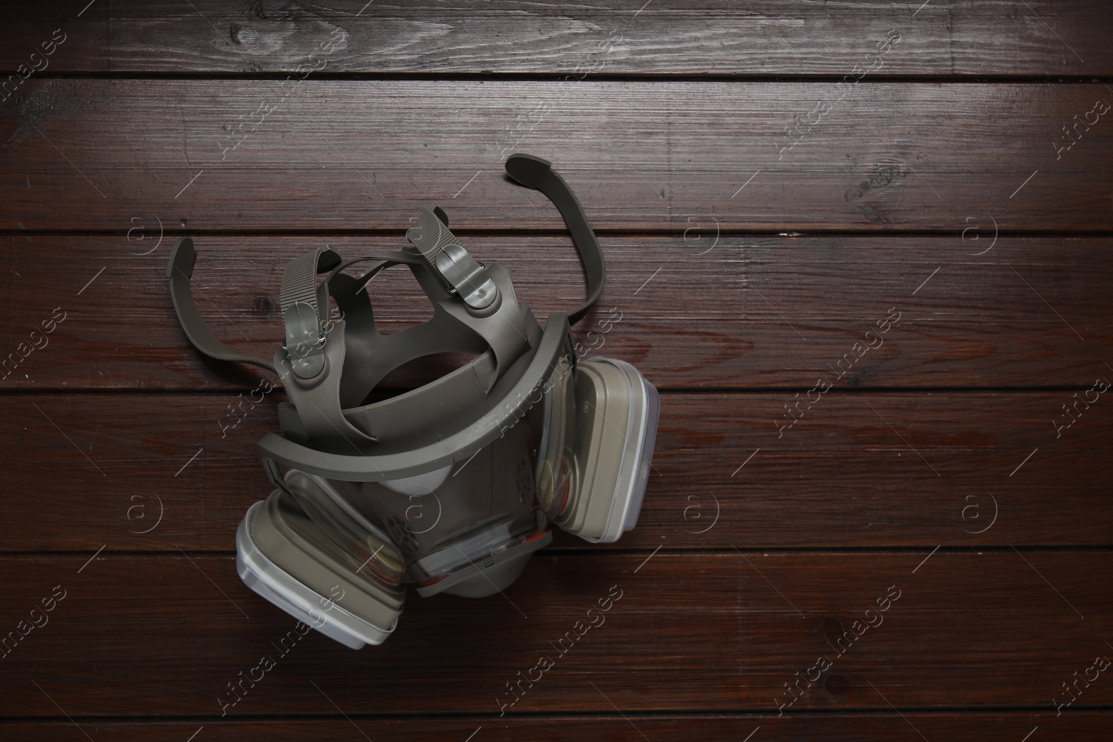 Photo of One respirator mask on wooden table, top view. Space for text