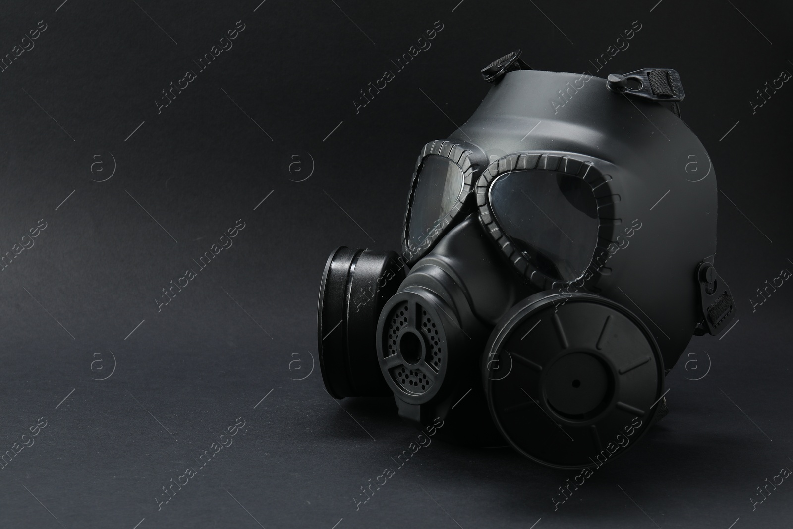 Photo of One gas mask on black background, space for text. Safety equipment