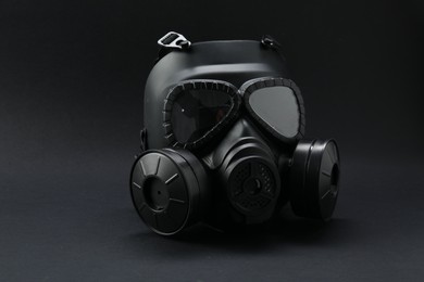Photo of One gas mask on black background. Safety equipment