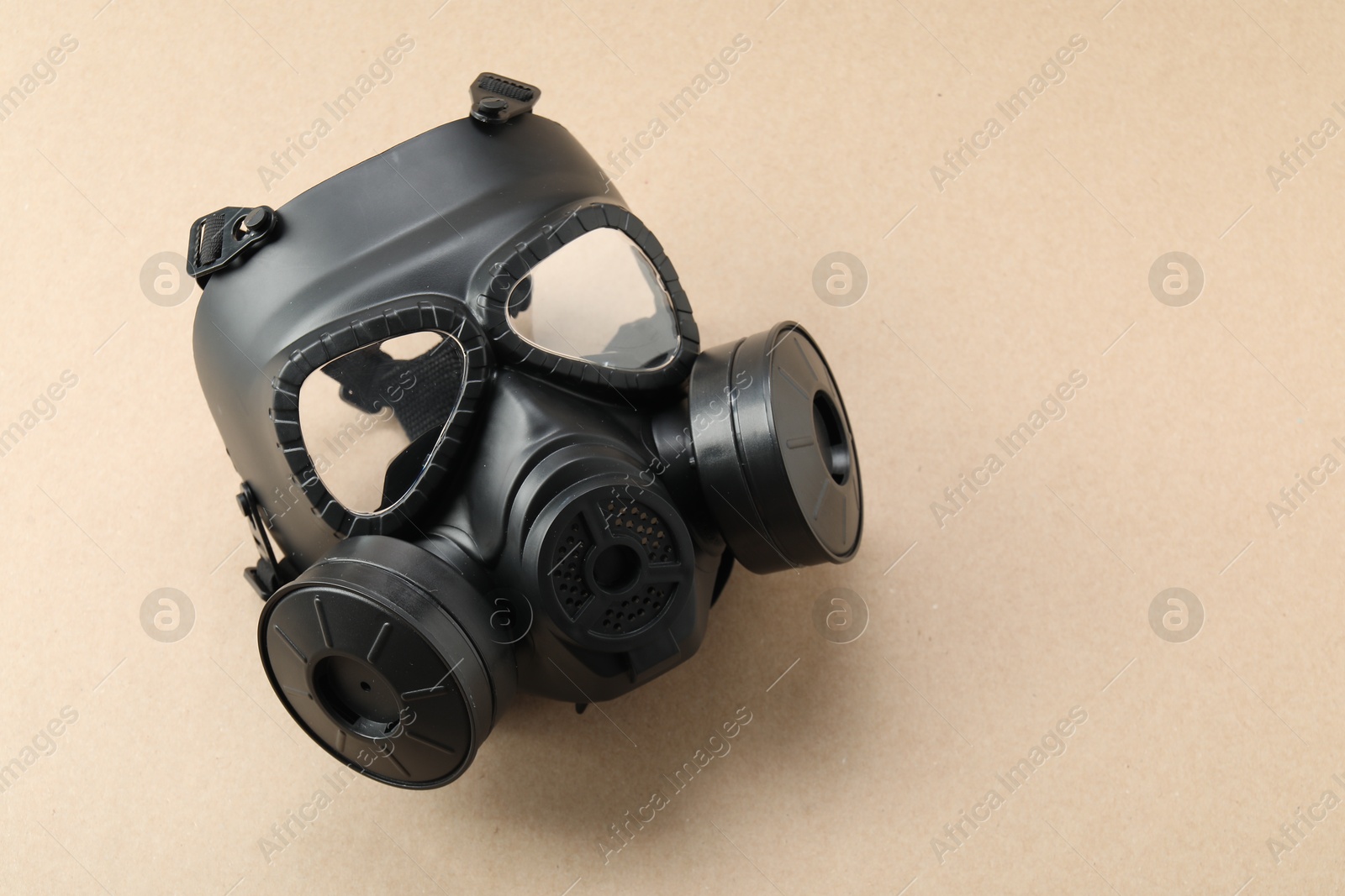 Photo of One respirator mask on beige background, top view and space for text. Safety equipment