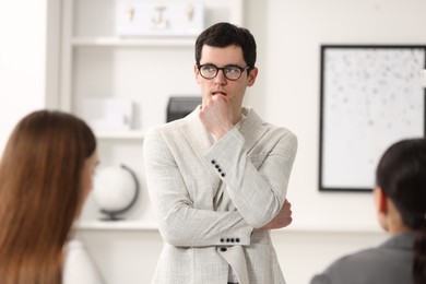 Photo of Man feeling embarrassed during business meeting in office