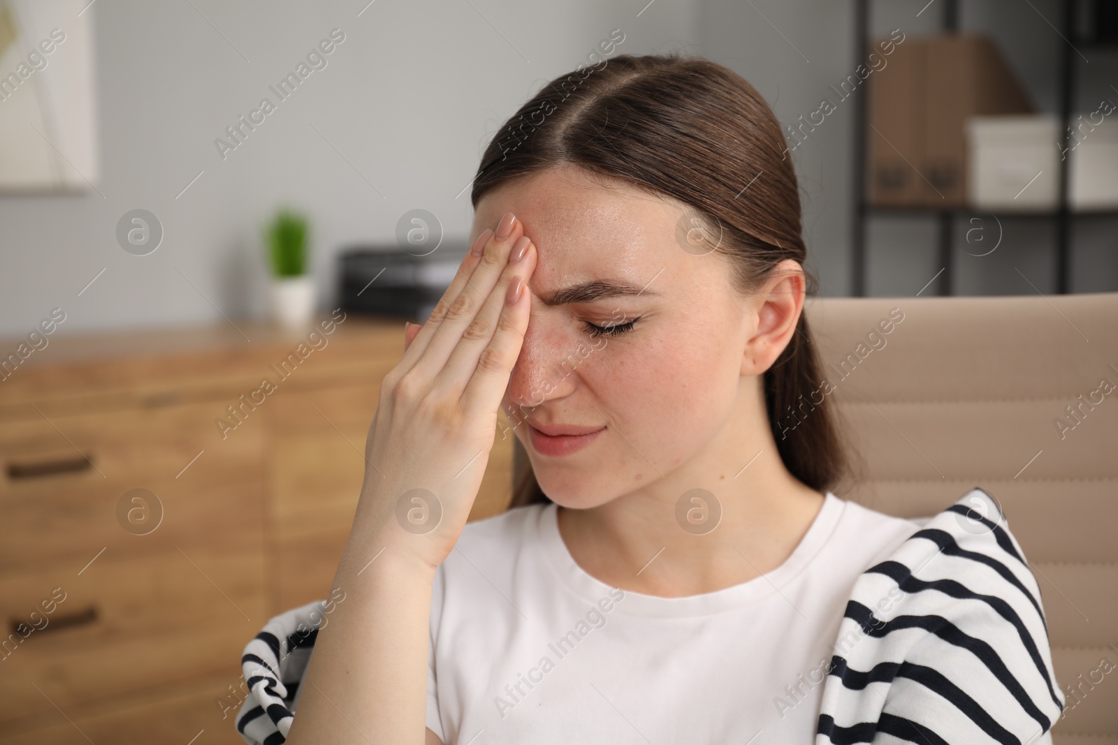 Photo of Portrait of embarrassed young woman in office