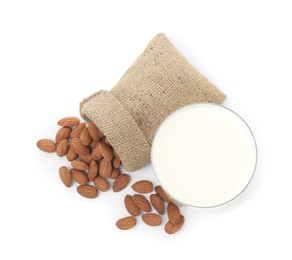 Glass of almond milk and almonds isolated on white, top view