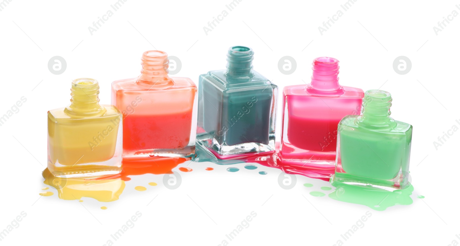 Photo of Many bottles and drops of colorful nail polishes isolated on white