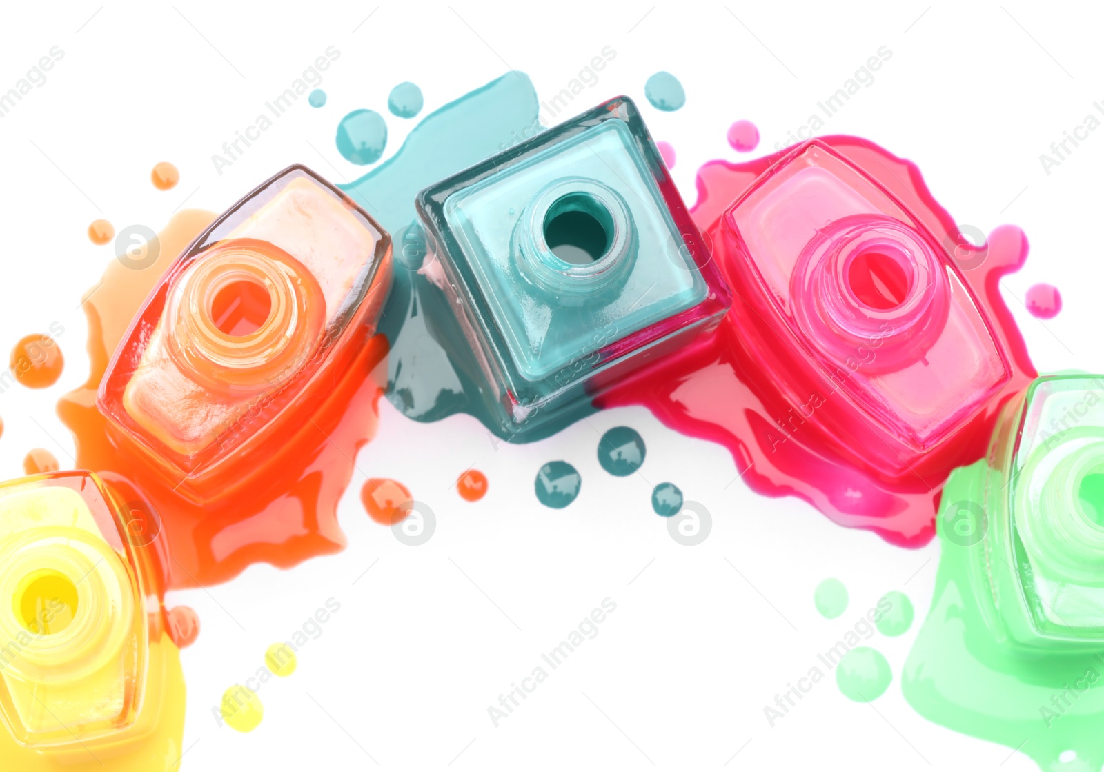 Photo of Many bottles and drops of colorful nail polishes isolated on white, top view