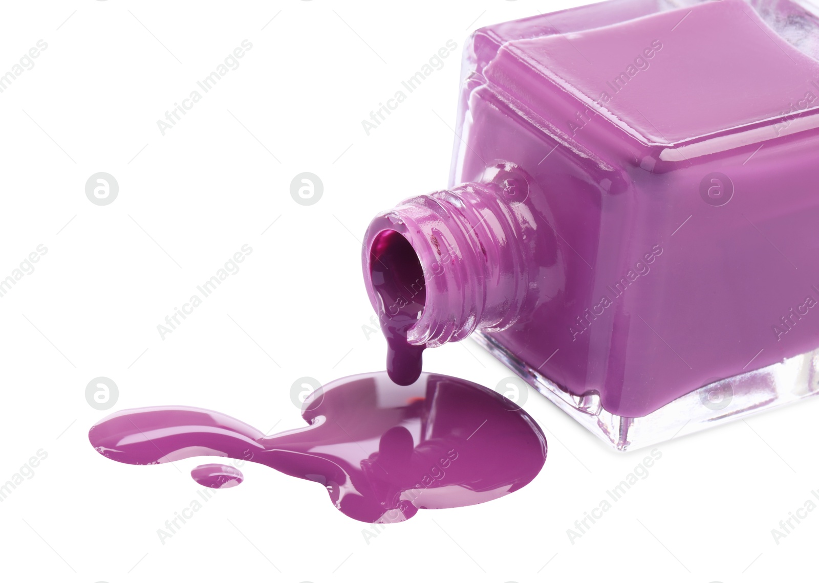Photo of Bottle and spilled purple nail polish isolated on white