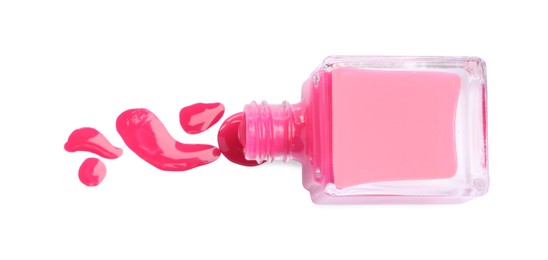 Photo of Bottle and spilled pink nail polish isolated on white, top view