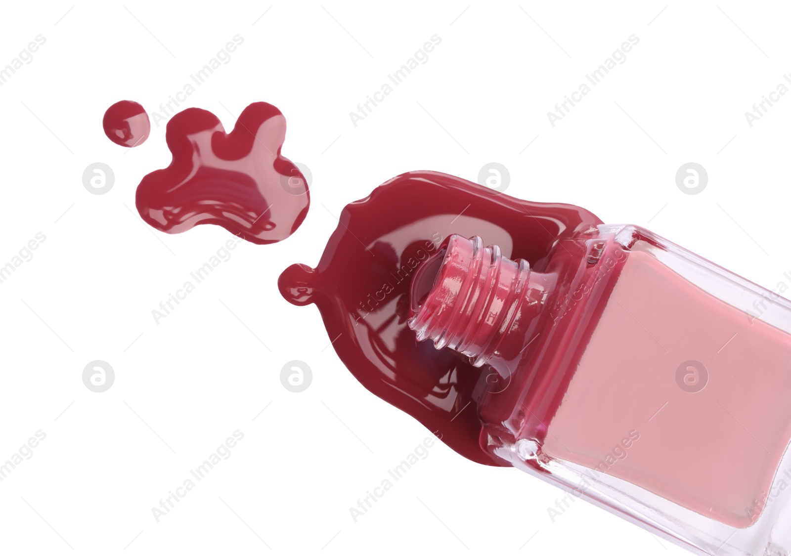 Photo of Bottle and spilled red nail polish isolated on white, top view