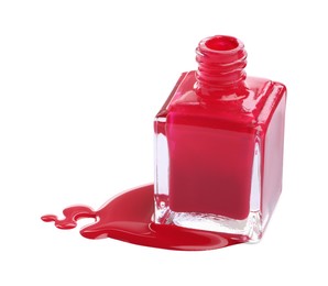 Photo of Bottle and spilled red nail polish isolated on white