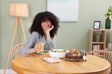 Woman having vegetarian meal at table in cafe