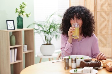 Woman having vegetarian meal at table in cafe