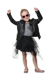 Photo of Cute little girl in sunglasses dancing on white background