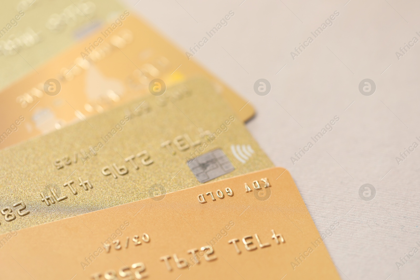 Photo of Many credit cards on gray background, closeup