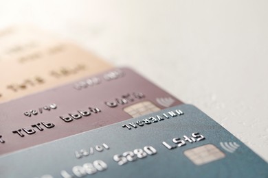 Photo of Many credit cards on gray background, closeup