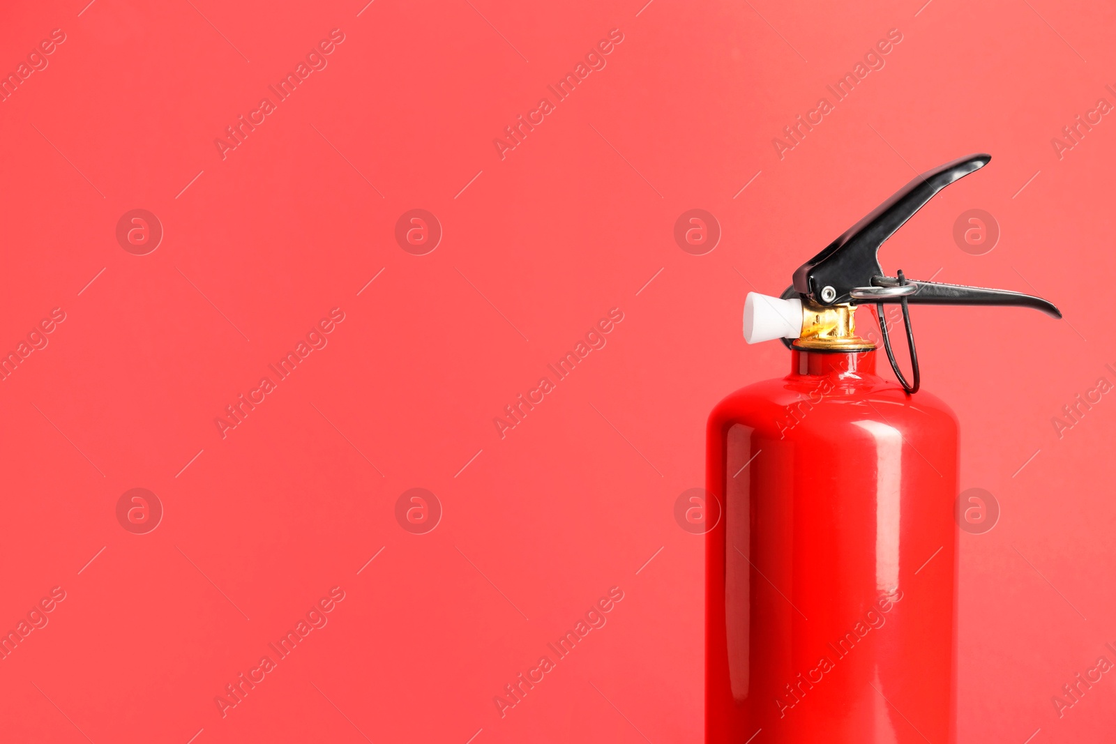 Photo of One fire extinguisher on red background, space for text