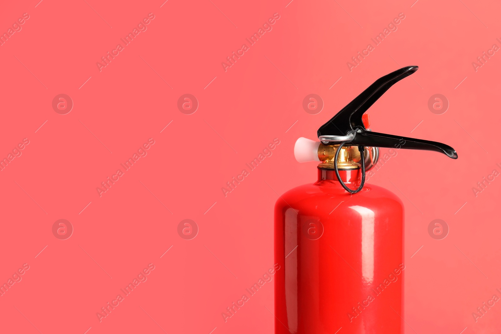 Photo of One fire extinguisher on red background, space for text