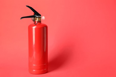 Photo of One fire extinguisher on red background, space for text