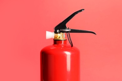 Photo of One fire extinguisher on red background. Safety equipment