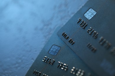 Photo of Plastic credit cards on table, closeup view. Space for text
