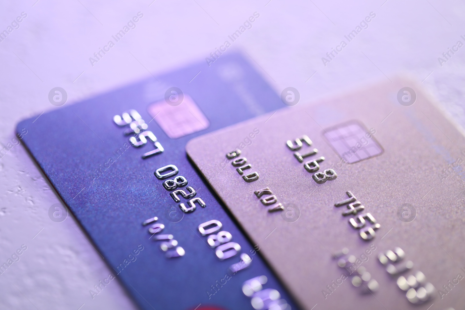 Photo of Plastic credit cards on table, closeup view. Color toned