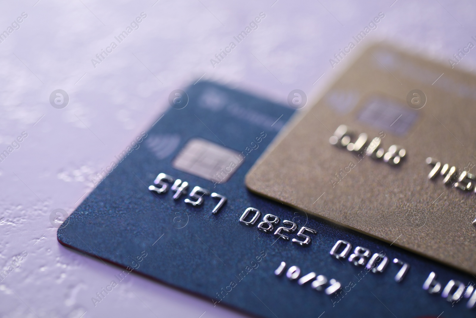 Photo of Plastic credit cards on table, closeup view. Color toned