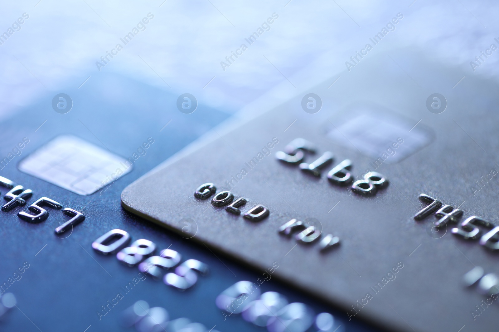 Photo of Plastic credit cards on table, macro view. Color toned