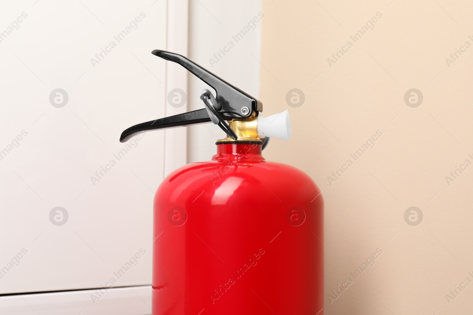 Photo of One fire extinguisher indoors, closeup. Safety equipment