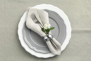 Stylish setting with cutlery and plates on table, top view