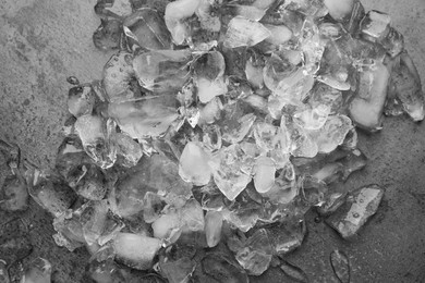 Pile of crushed ice on dark textured table, top view