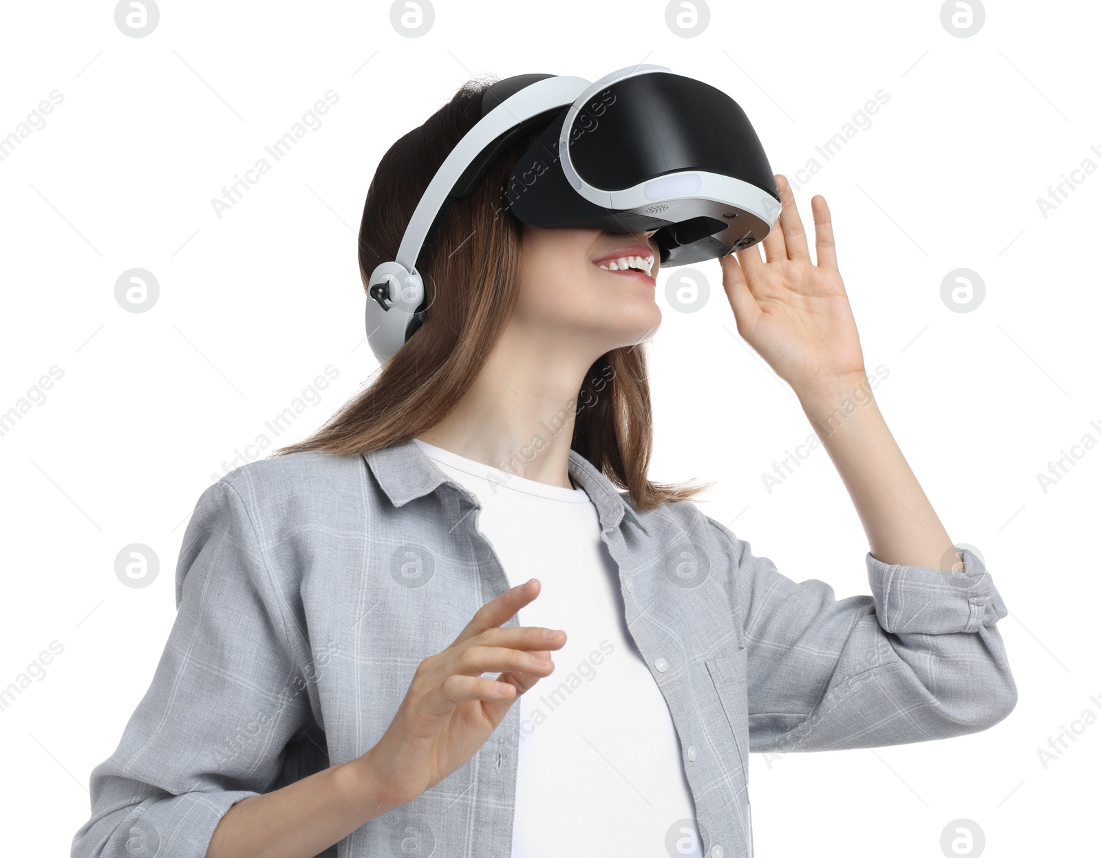 Photo of Smiling woman using virtual reality headset on white background