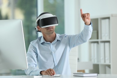 Man using virtual reality headset in office