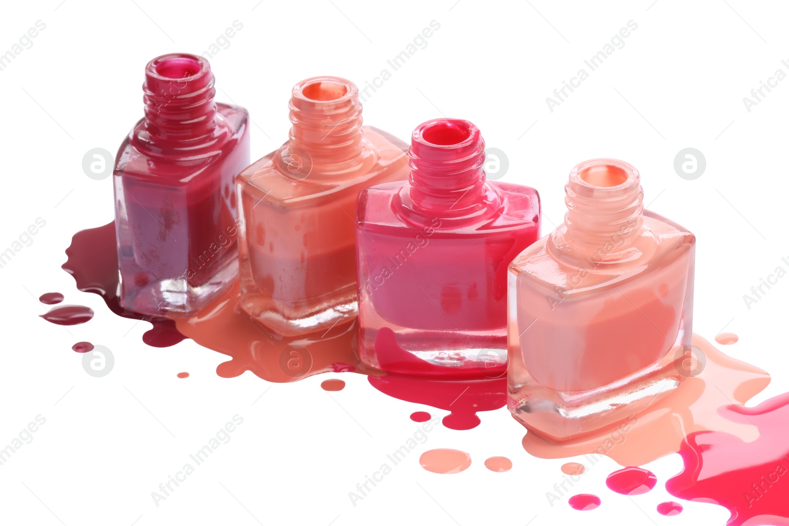 Photo of Many bottles and drops of colorful nail polishes isolated on white