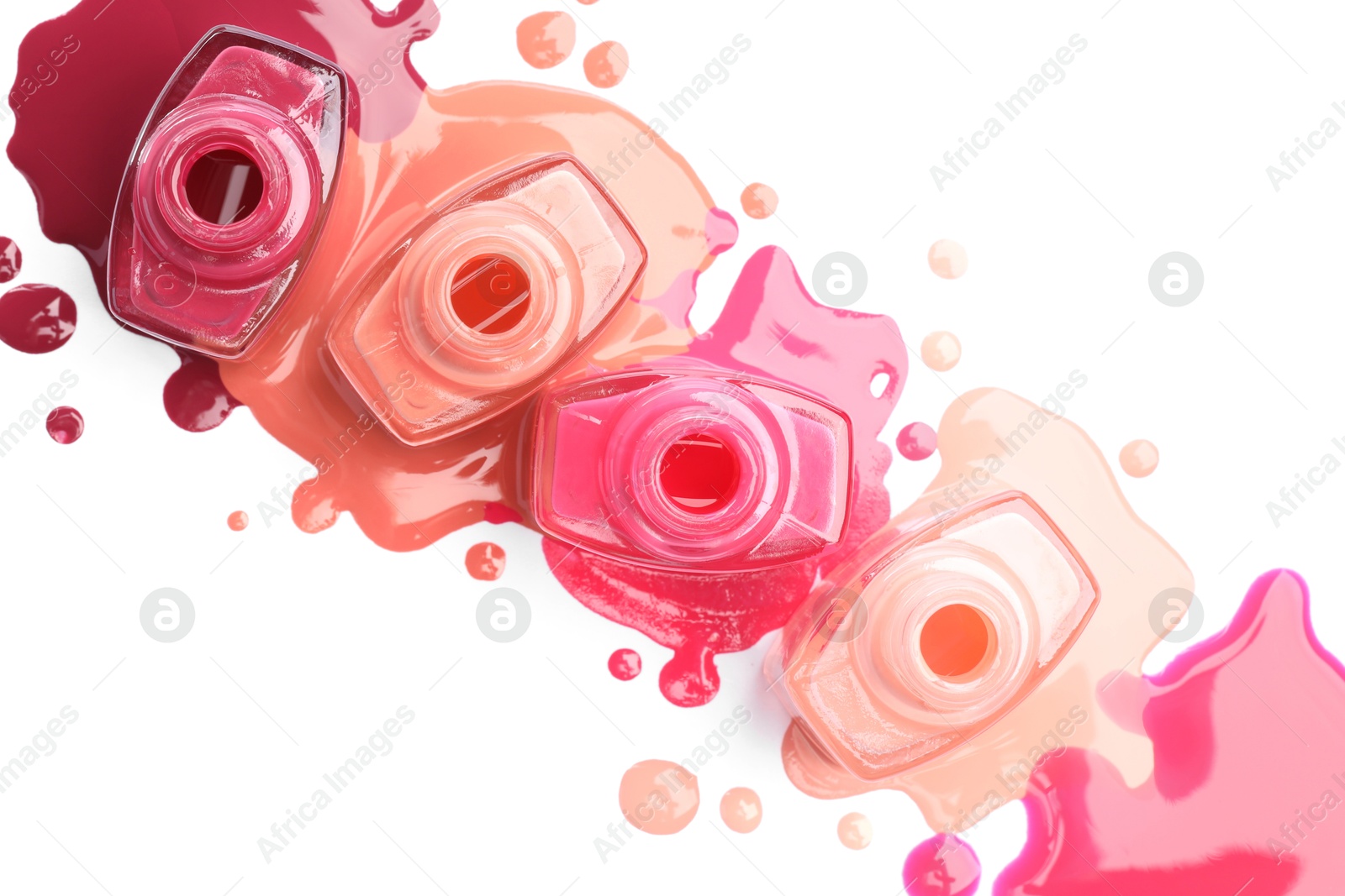 Photo of Many bottles and drops of colorful nail polishes isolated on white, top view