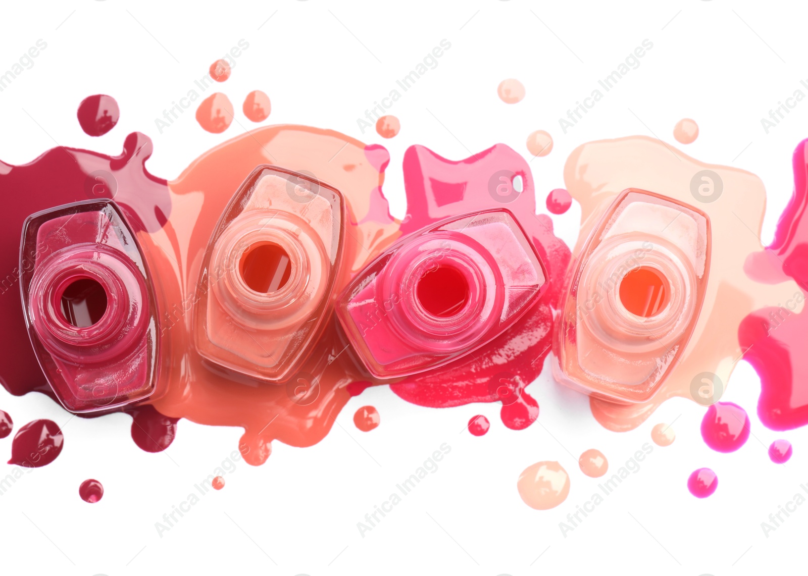 Photo of Many bottles and drops of colorful nail polishes isolated on white, top view