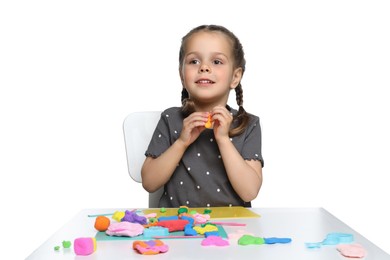 Little girl sculpting with play dough at table on white background