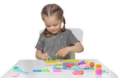 Photo of Little girl sculpting with play dough at table on white background