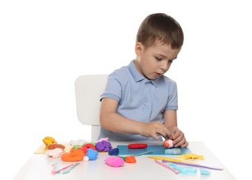Photo of Little boy sculpting with play dough at table on white background