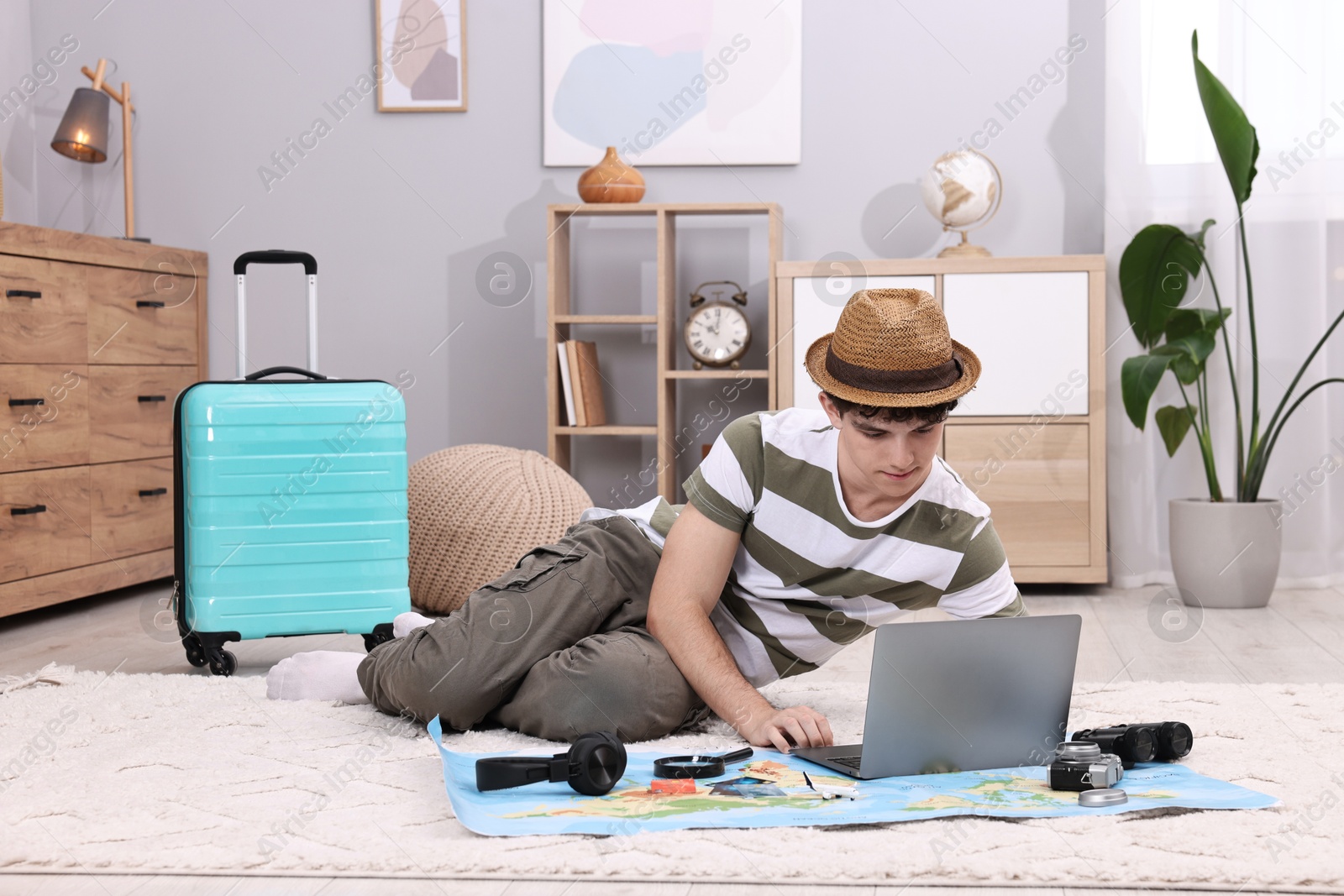 Photo of Travel blogger using laptop for planning trip at home