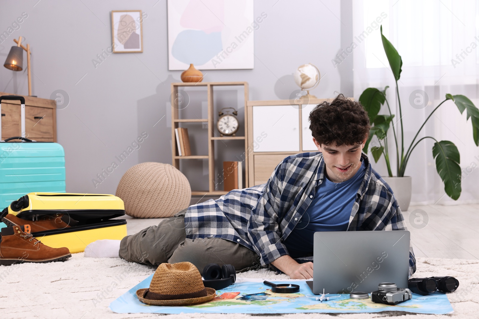 Photo of Travel blogger using laptop for planning trip at home