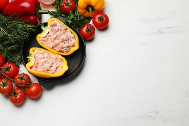 Raw stuffed peppers with ground meat and ingredients on white marble table, flat lay. Space for text