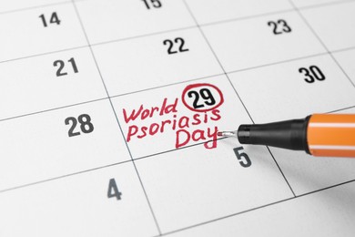Photo of International Psoriasis Day. Calendar page with marked date and marker, closeup