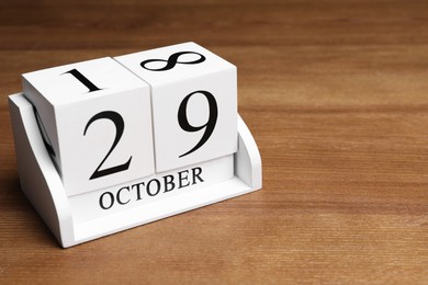 International Psoriasis Day - 29th of October. Block calendar on wooden table, space for text