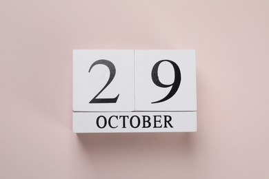 Photo of International Psoriasis Day - 29th of October. Block calendar on beige background, top view