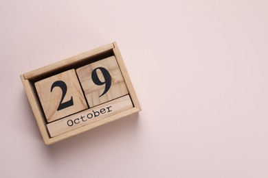 Photo of International Psoriasis Day - 29th of October. Block calendar on beige background, top view. Space for text
